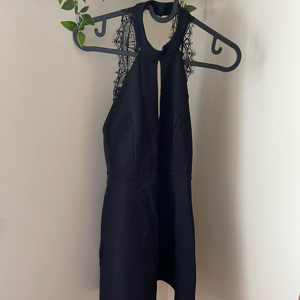 Black halter dress with lace detailing on the back
Size: S